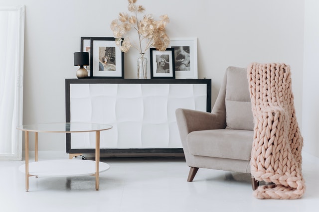 Beige sofa chair near a table.